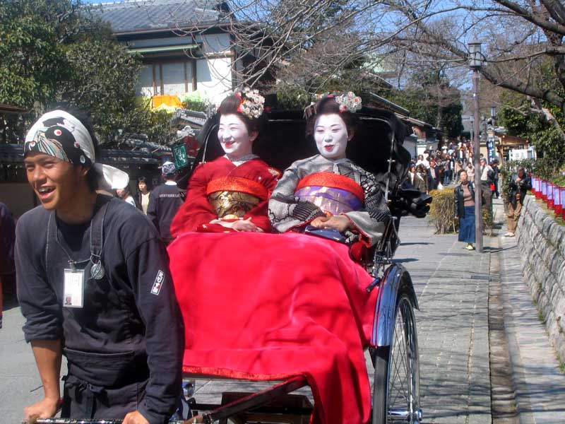 Maiko traveling by Rickshaw near Kiyomizu Dera
