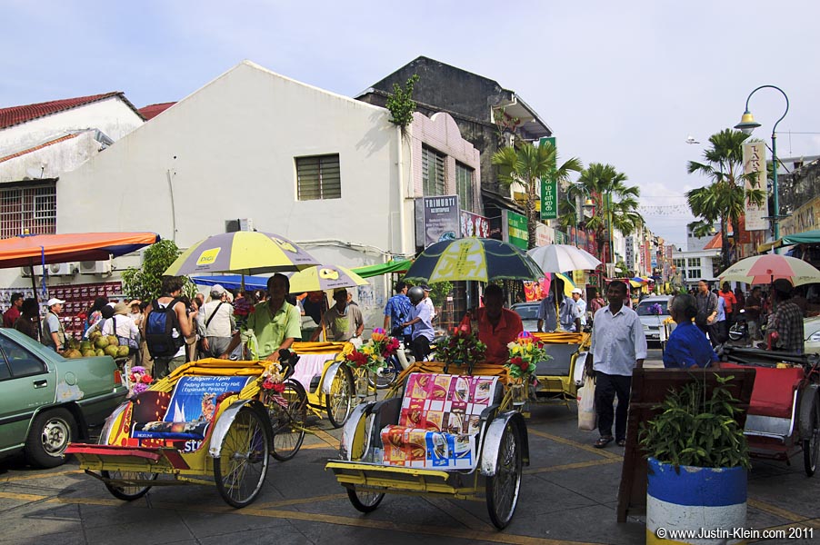 Colorful trishaws ferry people around town.